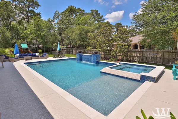 blue tile and white concrete pool