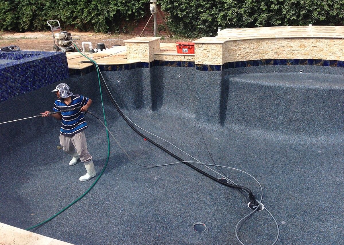 swimming pool builder finishing the interior of a pool